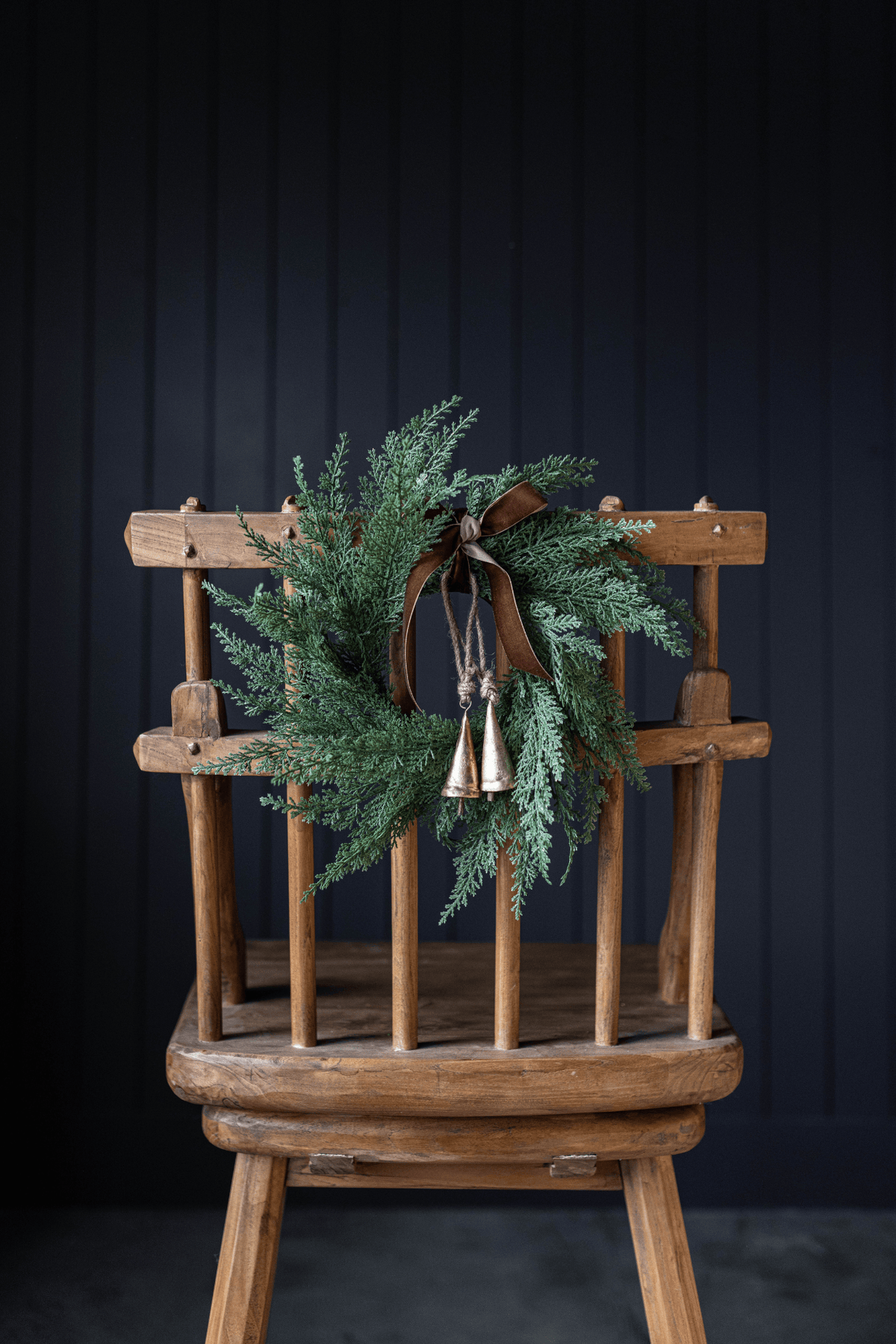 Green cypress leaf wreath with bow detail and hanging loop