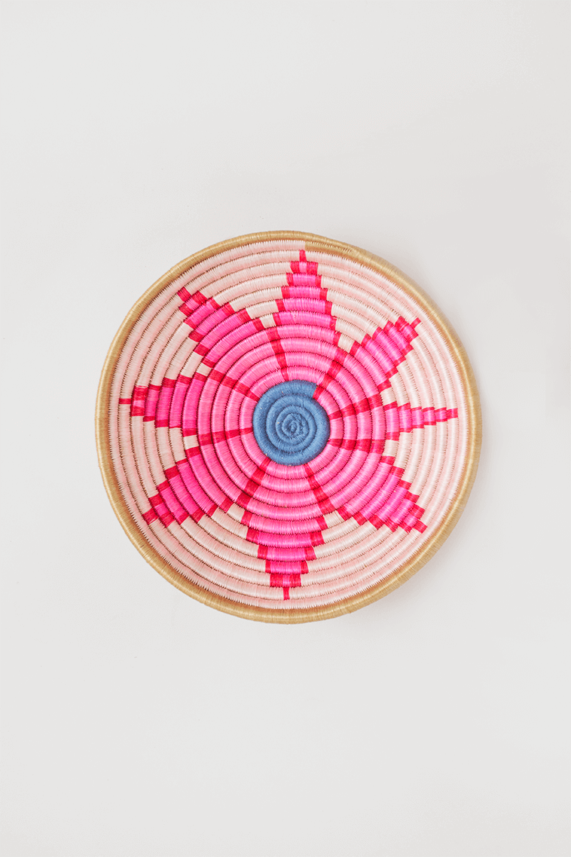 Round woven tray with natural rim and pink flower pattern, blue center