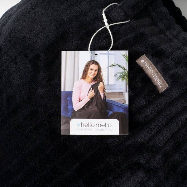 Hello Mello black blanket close-up with attached product tag.