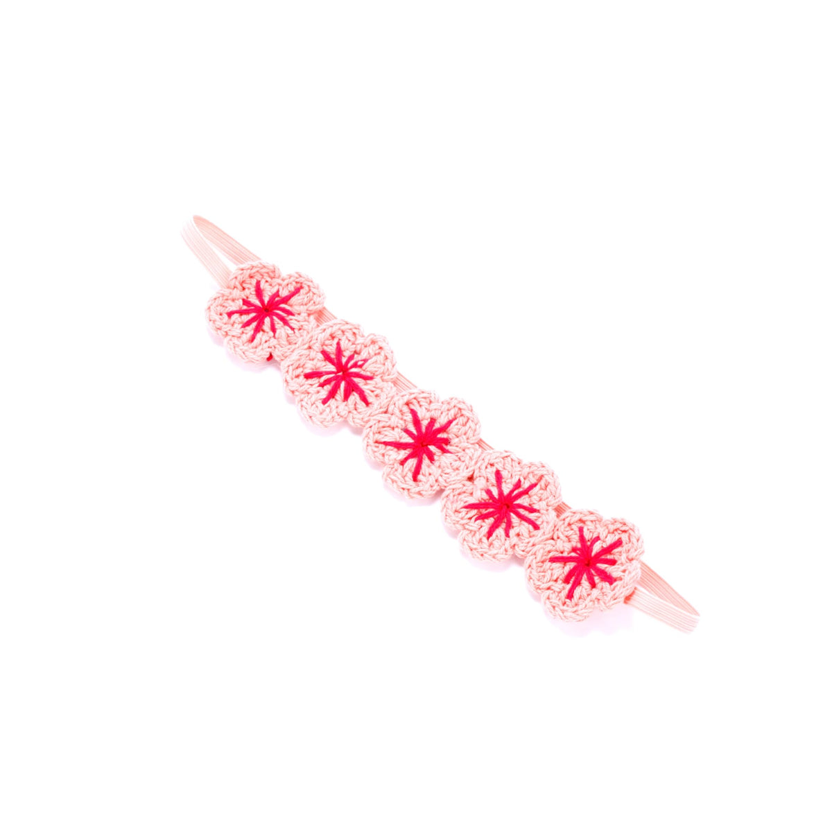 Pale pink knit flower crown headband with red centers and elastic ends