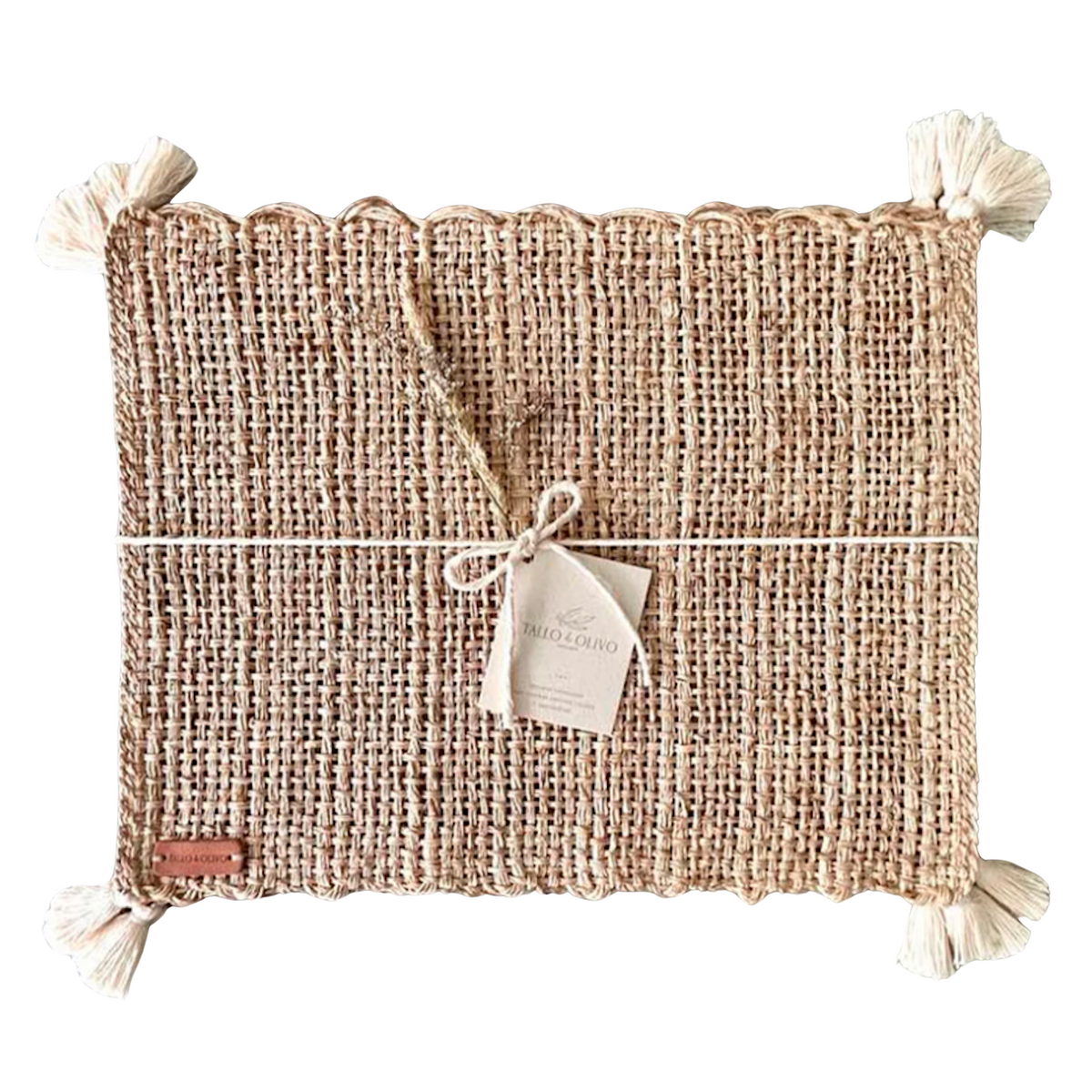 Rectangular woven placemat with tassel corners and centered brand tag