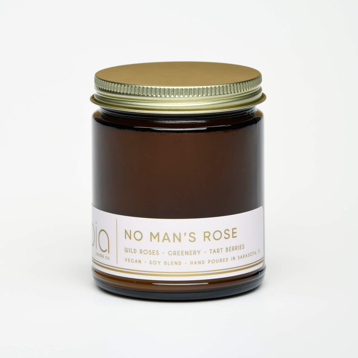 Brown amber soy blend candle jar with gold lid and printed label