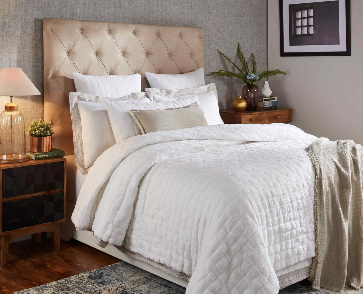 White pinched linen quilt with quilted stitch pattern and softly draped side folds