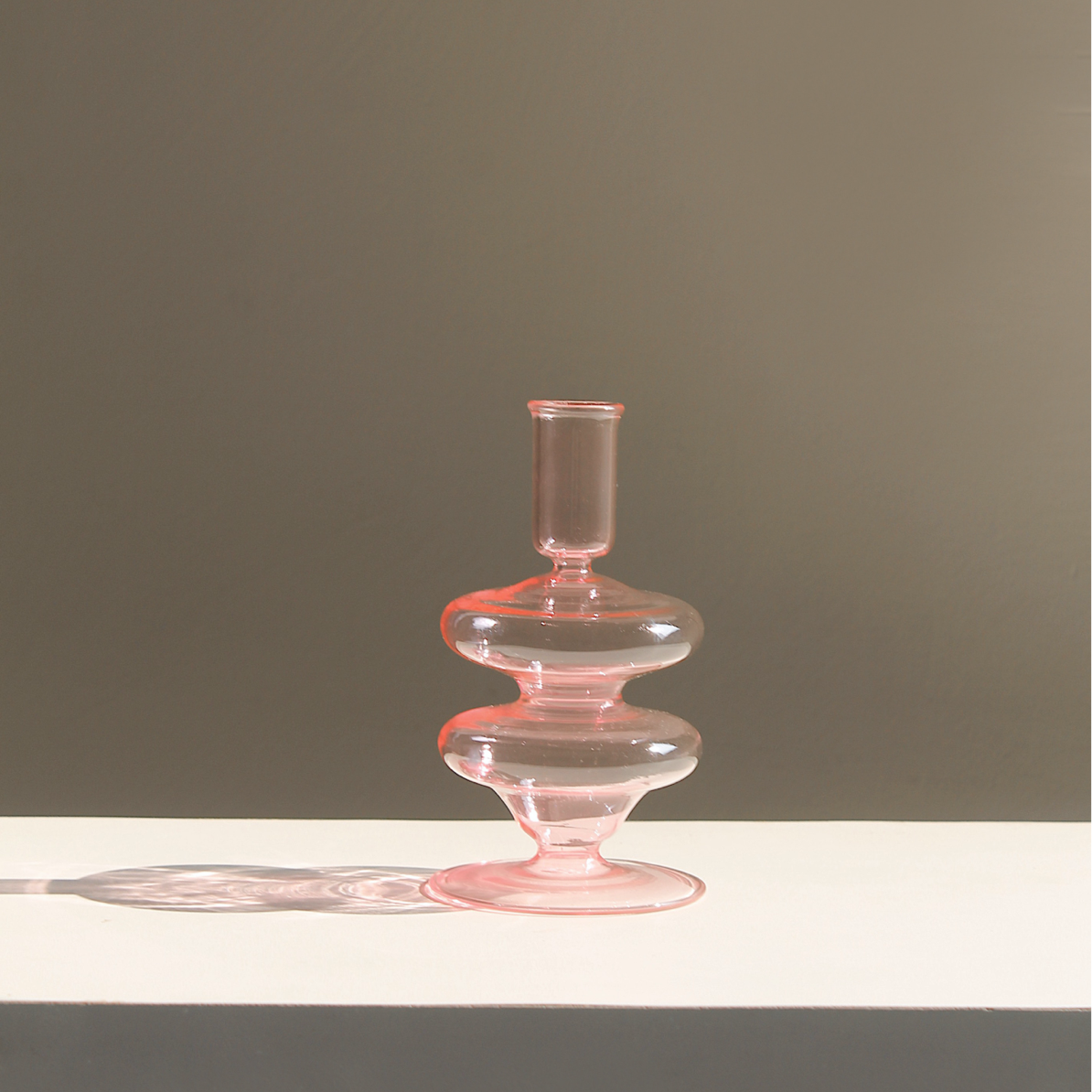 Siri pink glass candle holder with stacked bulb shapes and cylindrical cup top