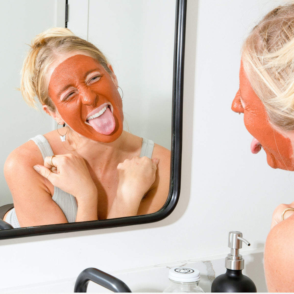 Rhassoul clay and rose face mask spread across a woman's face