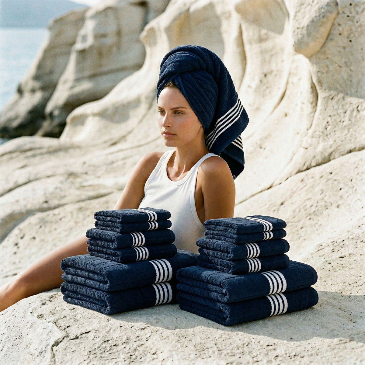 Nautilus Australian cotton towels, navy folded stack with white striped bands held by model