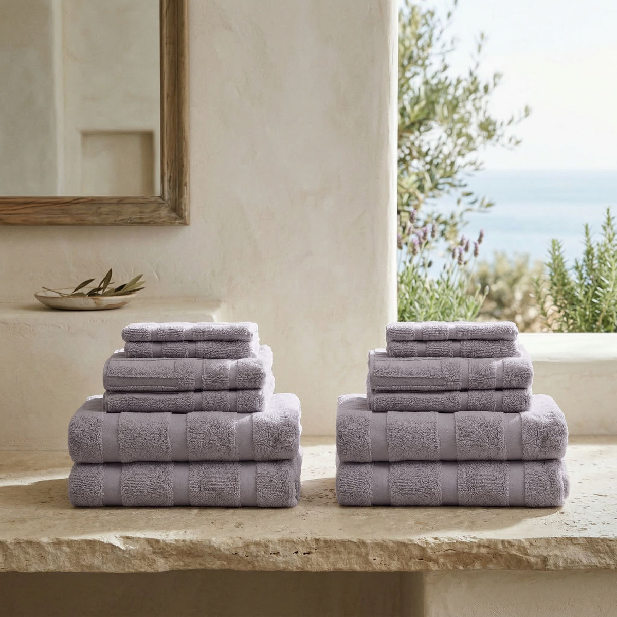 Lavender terry towel set, folded with vertical stripe pattern and solid edges.