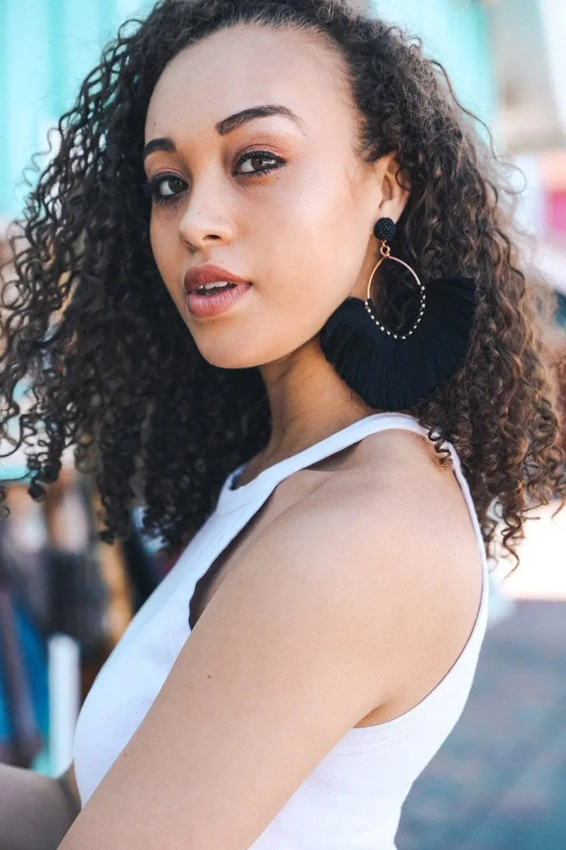 Black fan tassel earrings with circular top and long fringe tassels