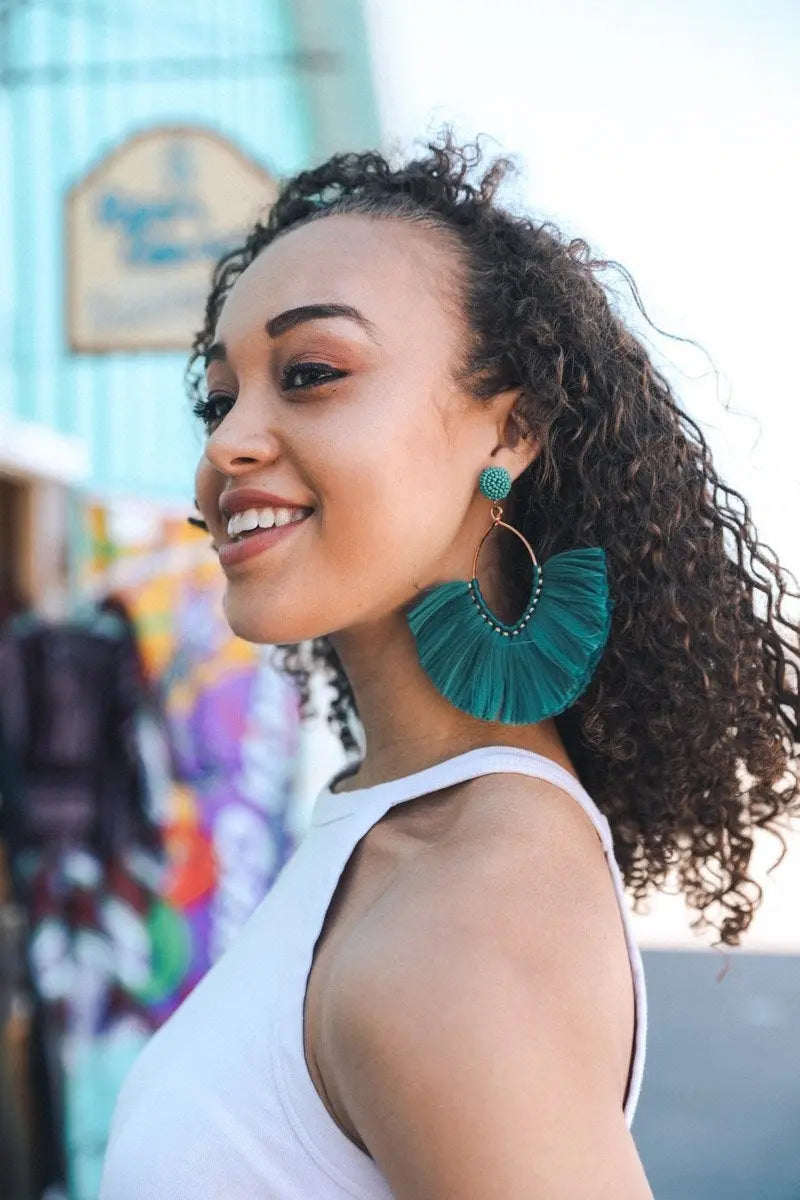 Teal fan tassel earrings with fringed fan silhouette and gold-tone hoop frame