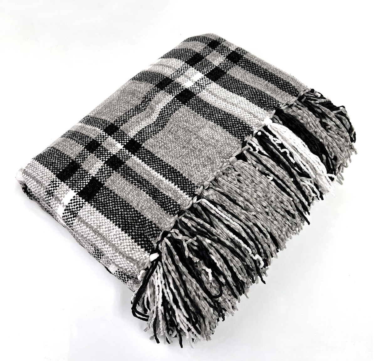 Plaid tassel throw blanket folded with black, white, and gray check stripes and fringe
