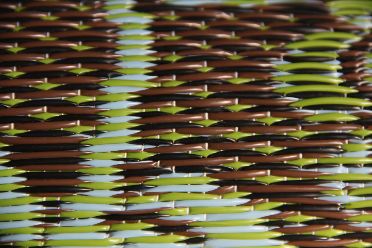 Outdoor mat surface with green, brown, and beige woven striped texture