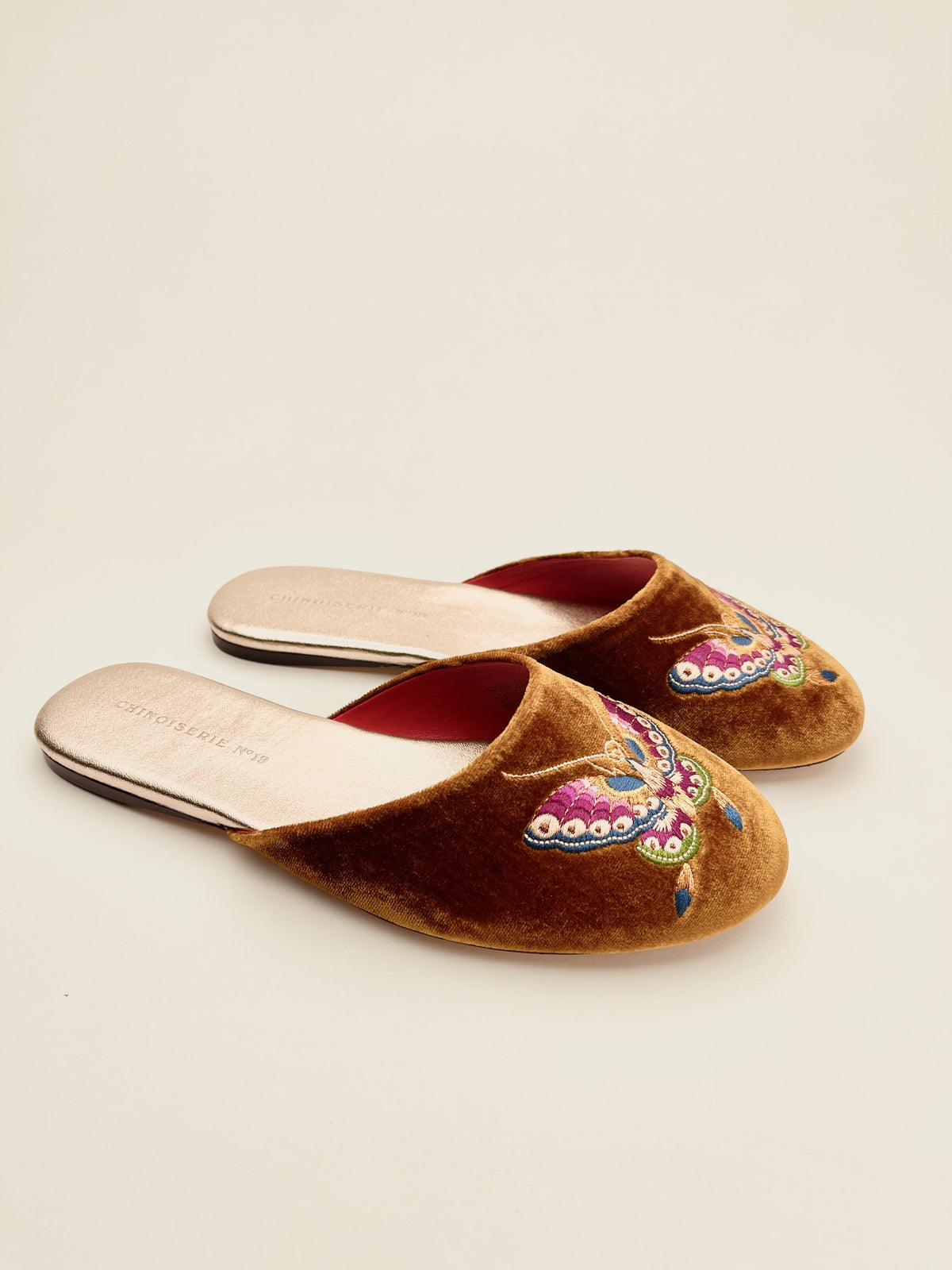 Velvet mule slippers in antique gold with butterfly embroidery, side view
