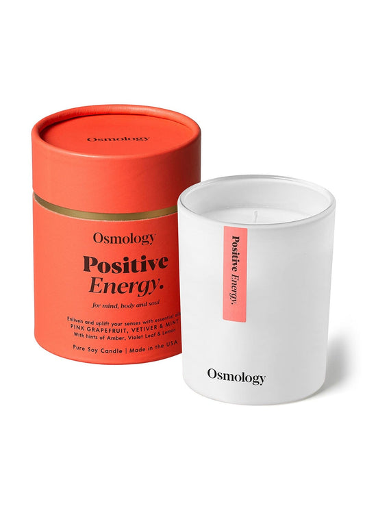 Scented candle pair in orange-red and white tins, both with visible wicks (Osmology)