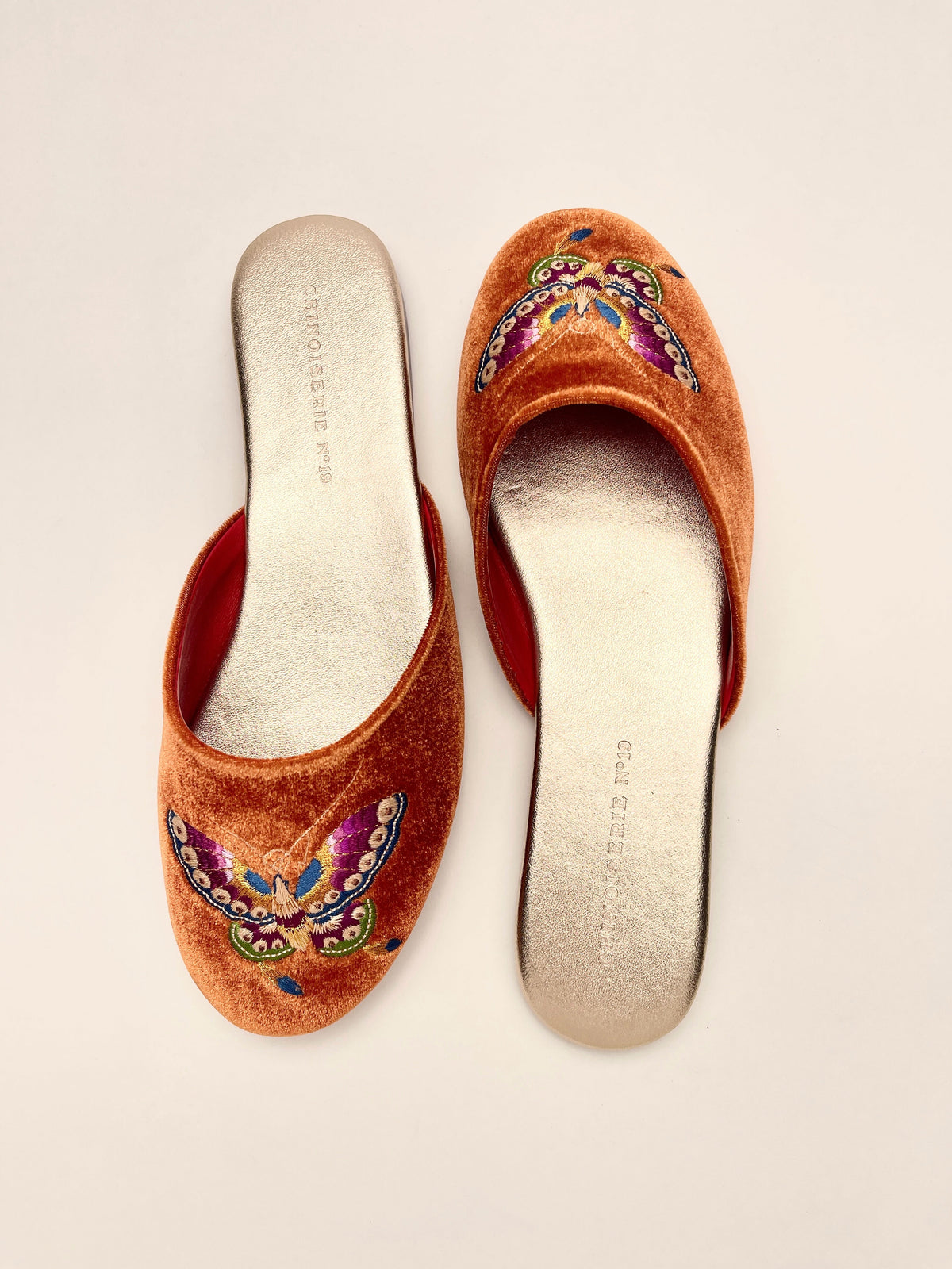 Burnt orange velvet mules with butterfly embroidery, open back and padded insole