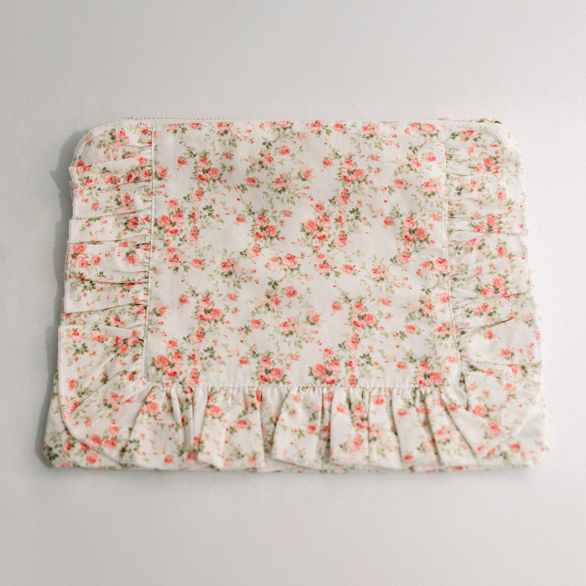 White floral ruffle zipper pouch, front view with pleated panels
