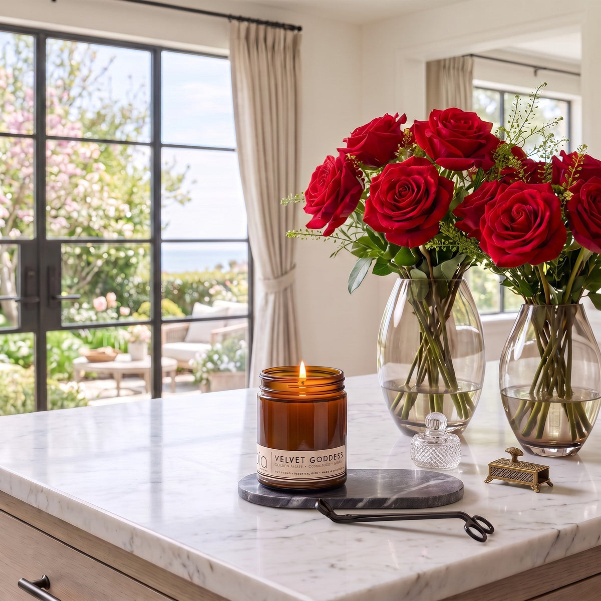 Lit amber glass jar candle on countertop with visible front label