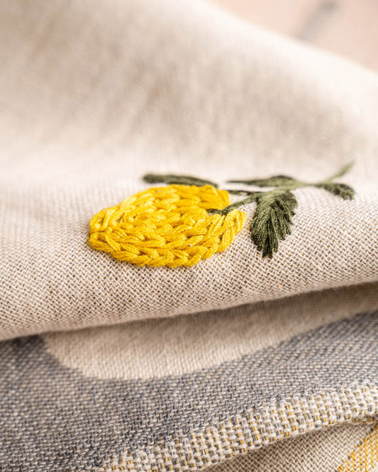 Kitchen towel with lemon applique and green leaves; light fabric, check border, fringe