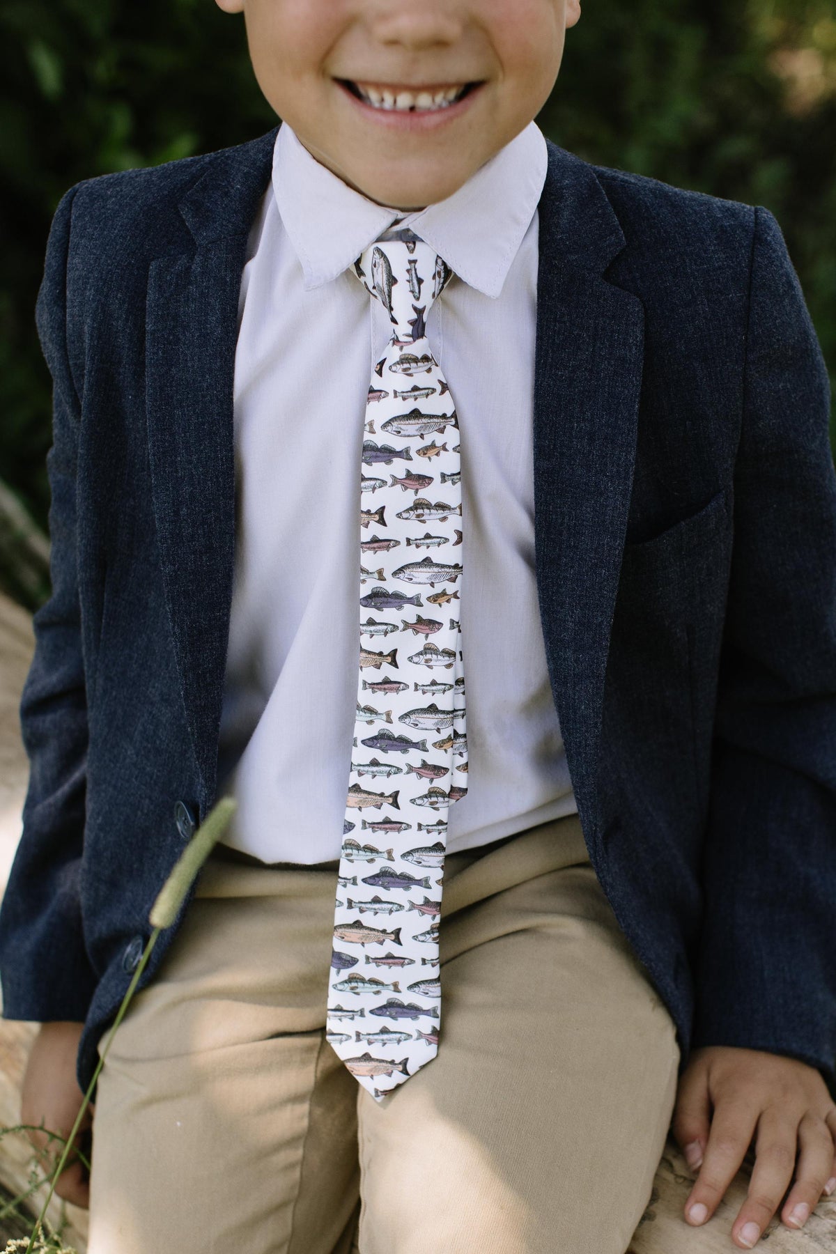 Boys fish print necktie with white shirt under a navy blazer