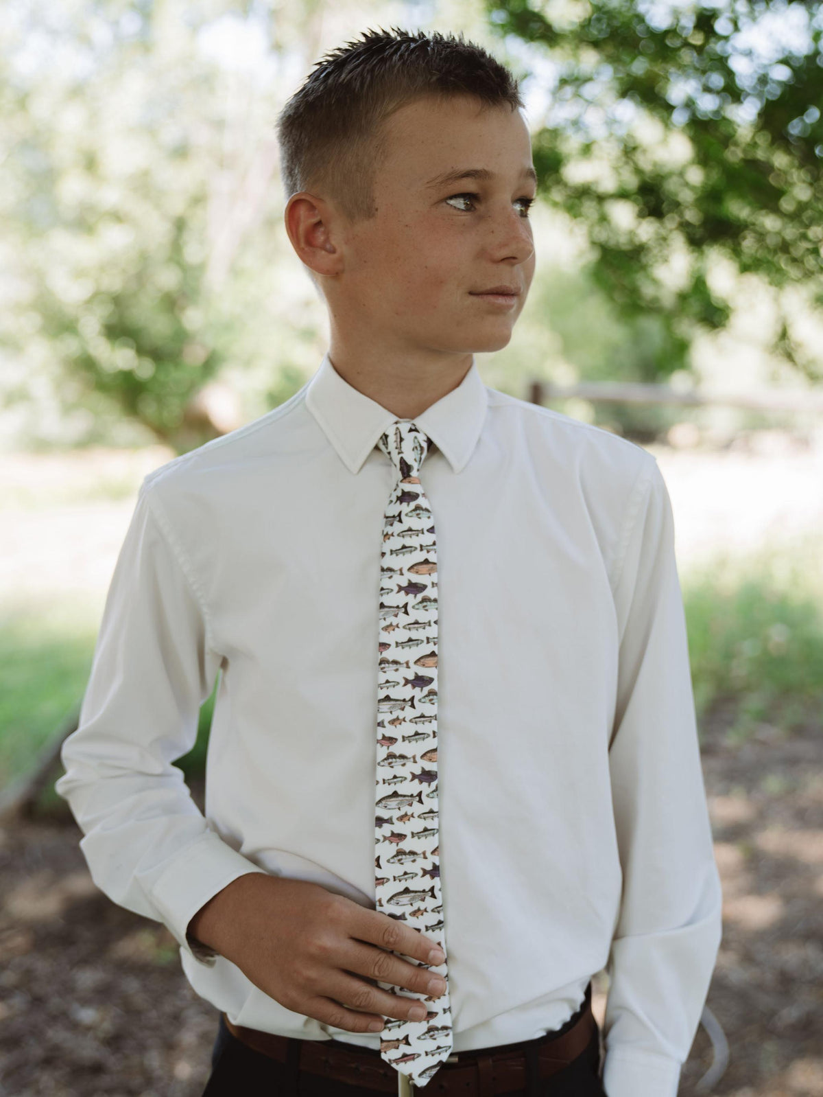 Boys fish print necktie on a white shirt with a brown belt
