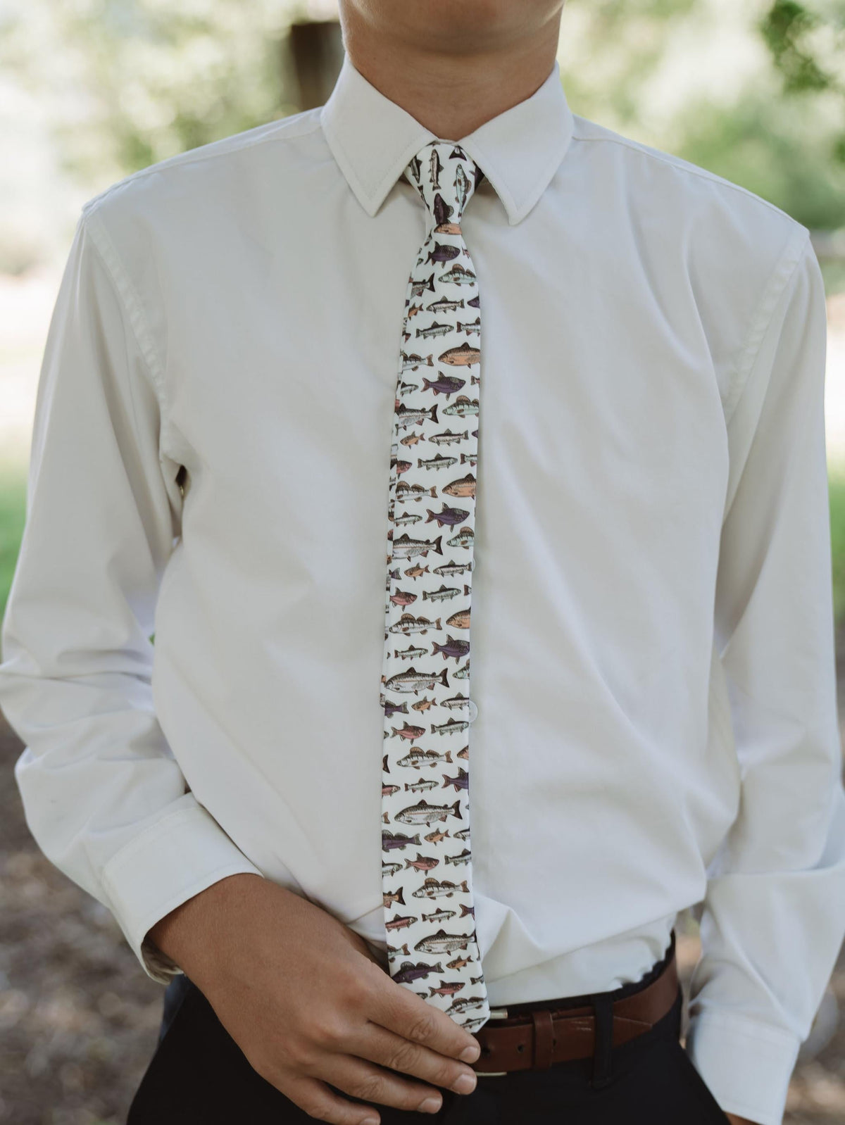 Boys fish print necktie worn with a white button-up shirt