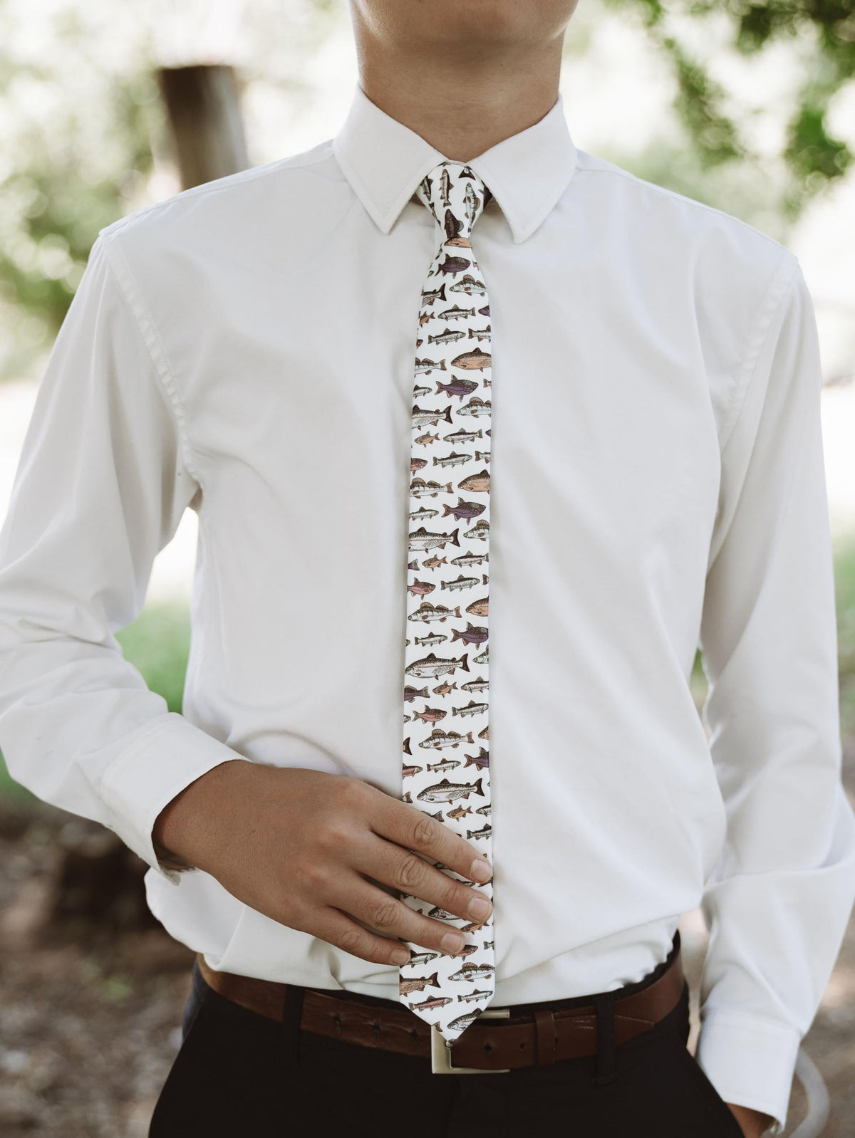Youth necktie with white background and fish print, worn with white dress shirt
