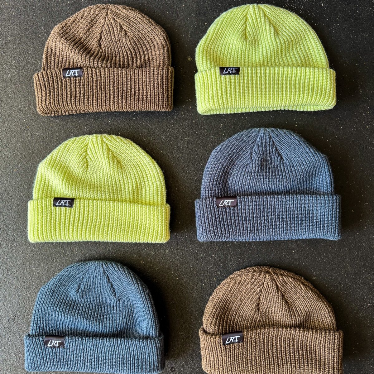 Knit beanie set featuring lime, blue, brown, and gray beanies with LRT tags