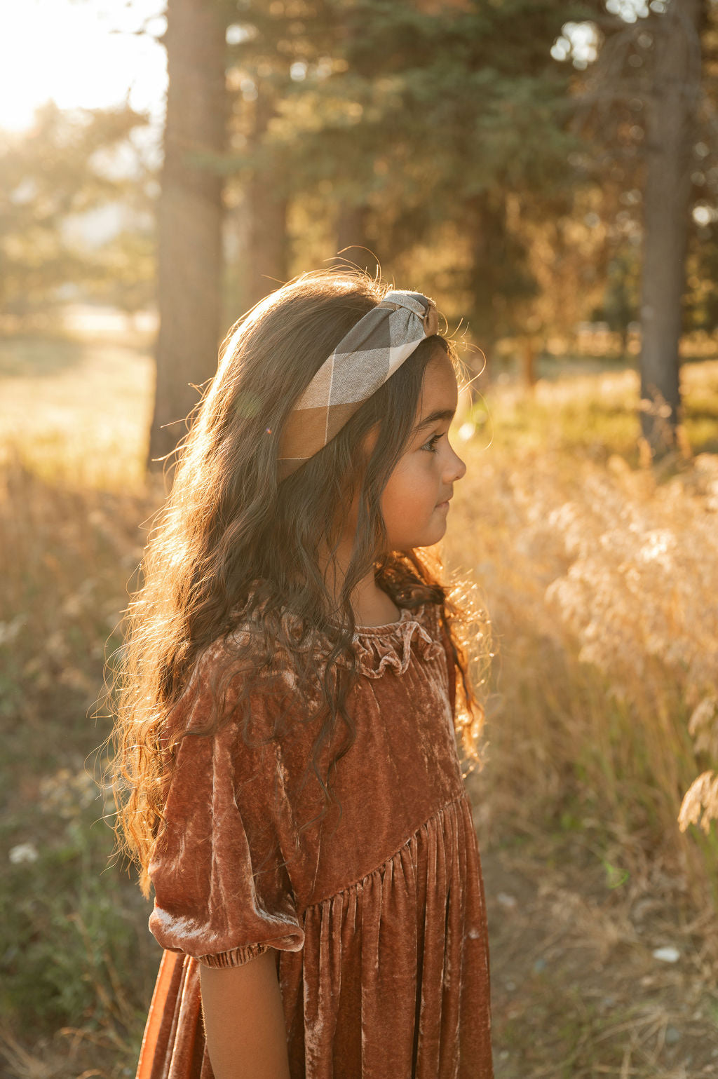 Plaid knotted headband worn on hair, side view with tan and dark charcoal tones