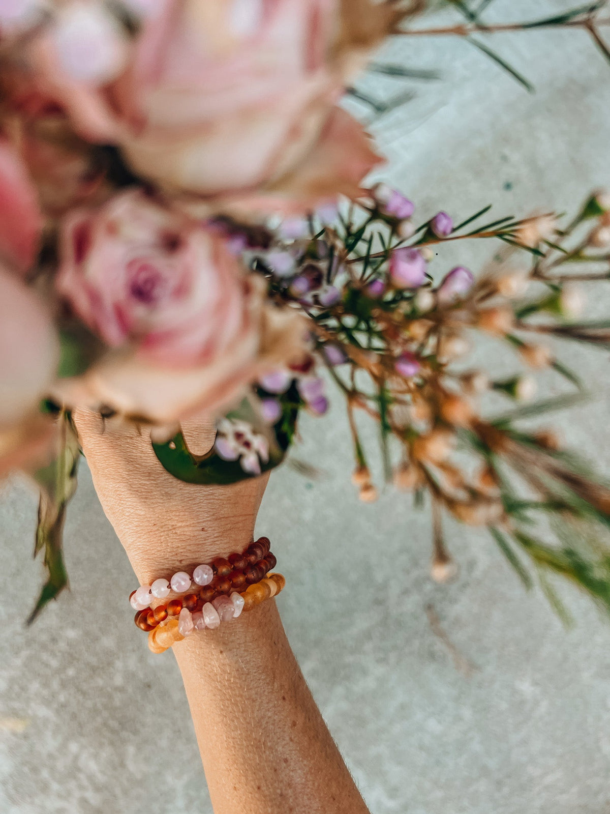 Amber and white bead bracelet worn on wrist, mixed beads on elastic band