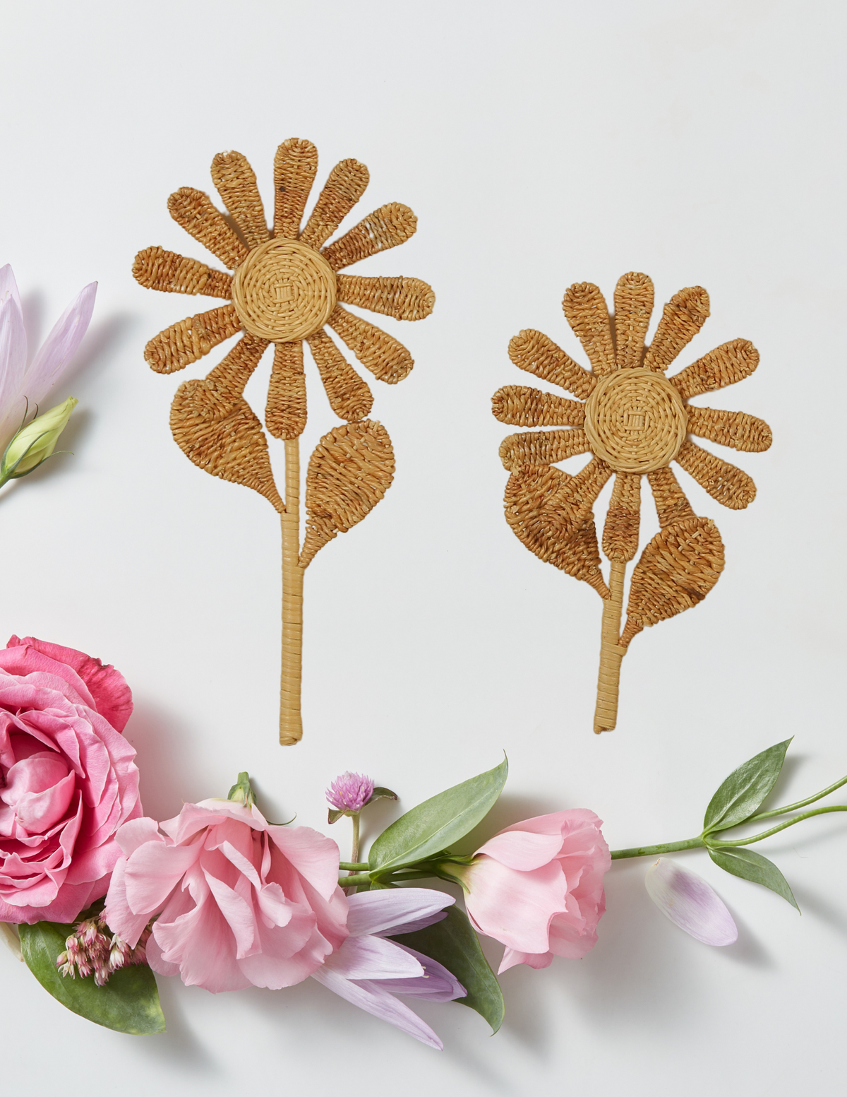 Pair of handcrafted rattan flower stems with woven petals, leaves, and long stems