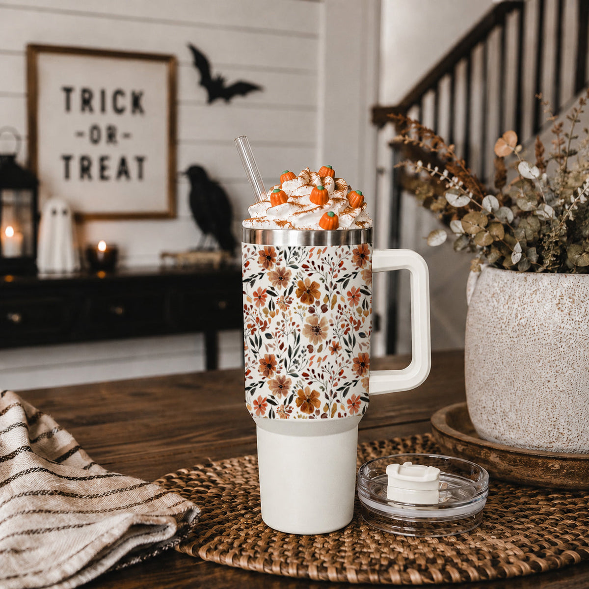 Floral 40oz tumbler with clear lid and straw, sitting on a tabletop
