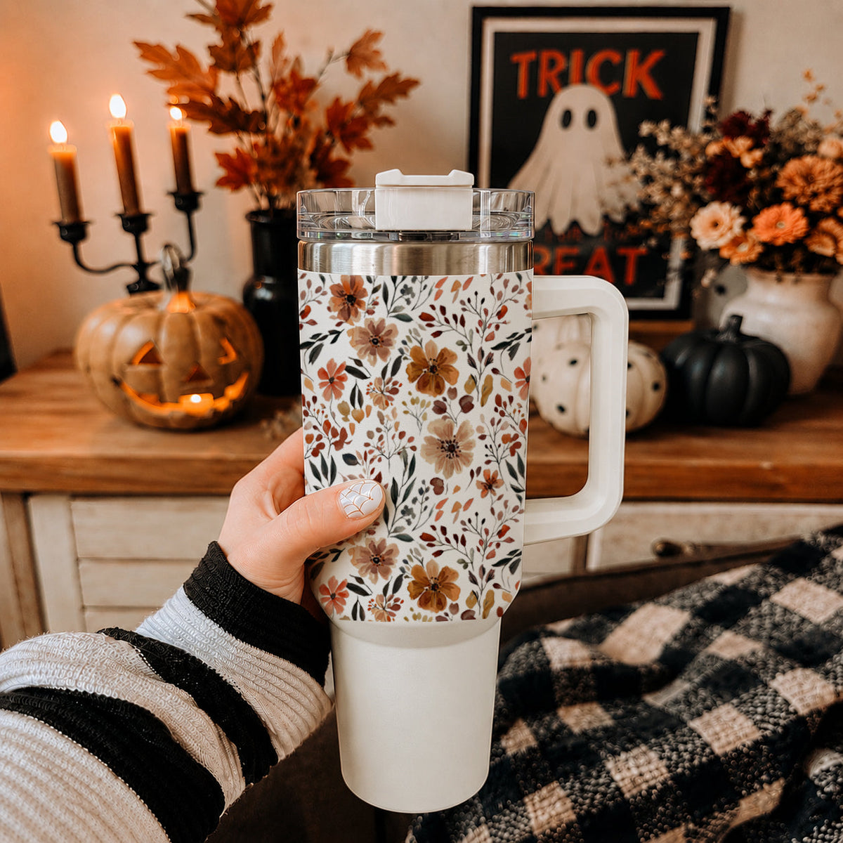 Floral 40oz tumbler with clear lid and straw, held with side handle visible