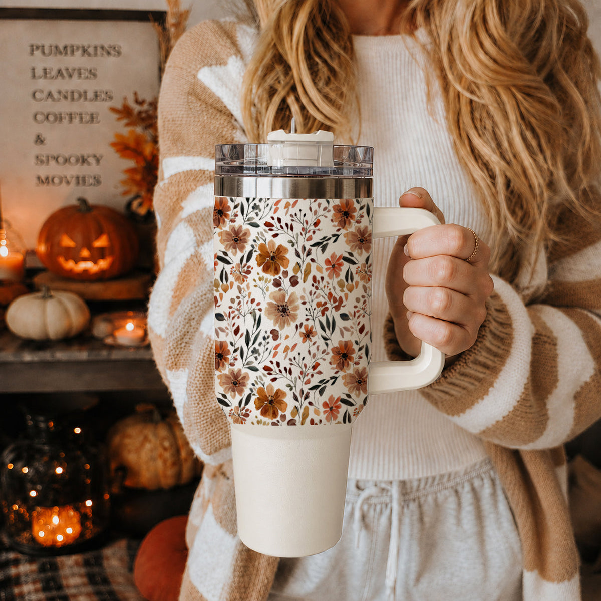 Floral 40oz tumbler with clear lid and straw, held close to the camera
