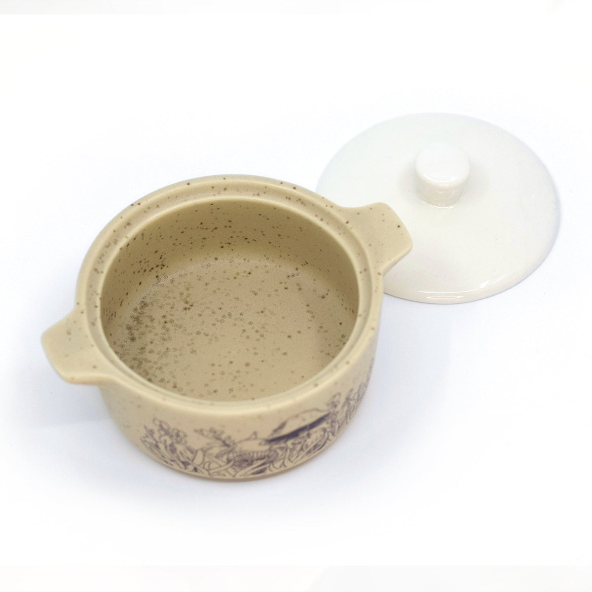 Beige ceramic trinket box with lid set aside; speckled interior and forest motif