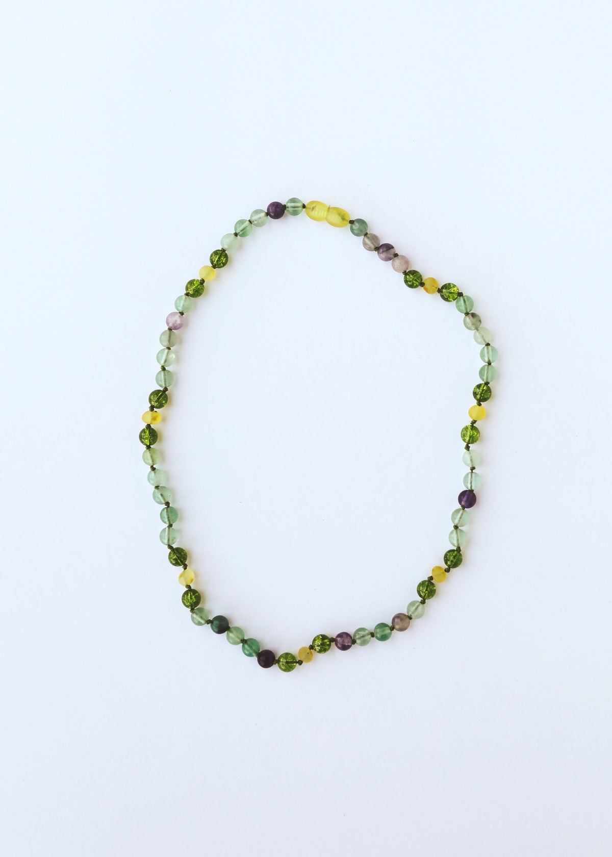 Gemstone bead necklace with a rounded loop, green and yellow stones with purple accents