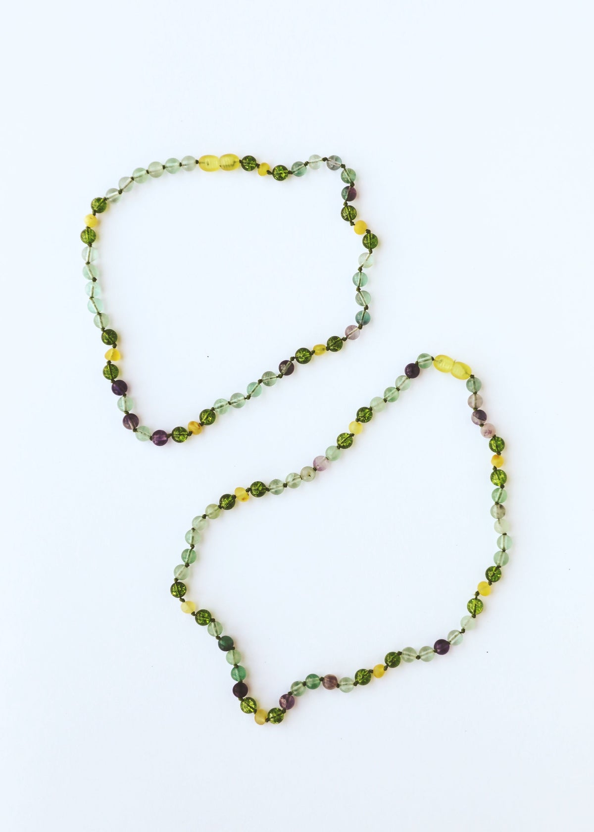 Two gemstone beaded bracelets with green, yellow and purple round faceted beads
