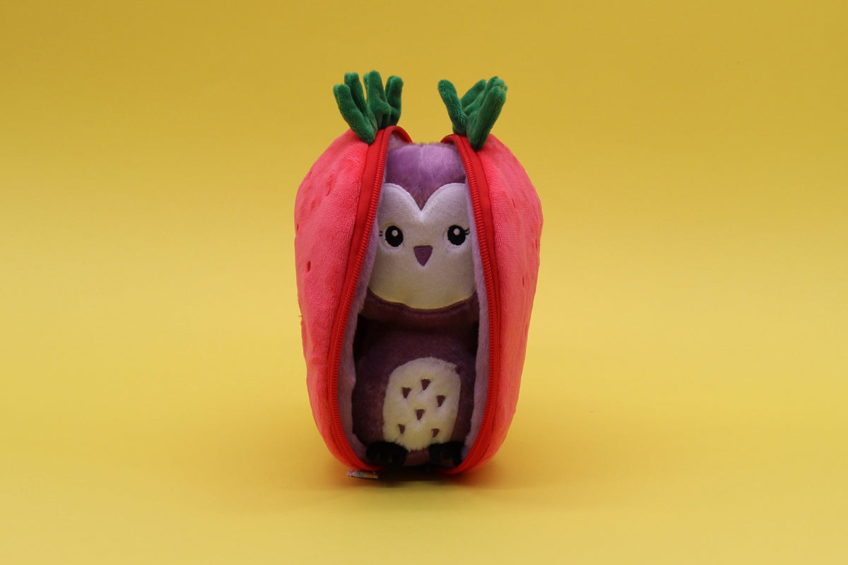 Plush owl inside red strawberry pouch with green leaves, front view