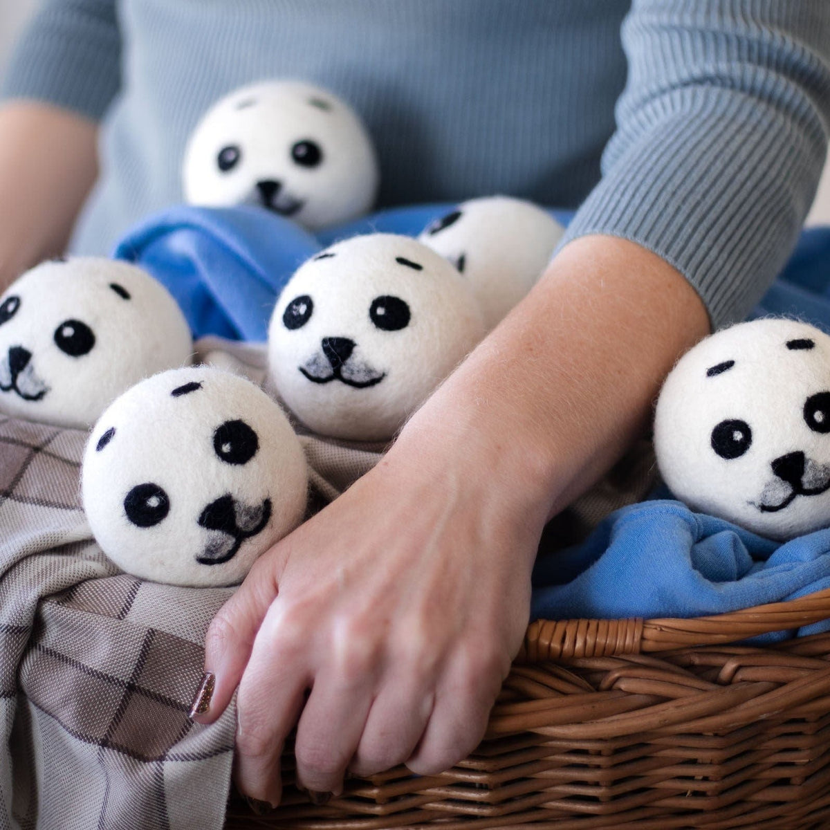 Round panda plush toy set nestled in a wicker basket with blue cloth