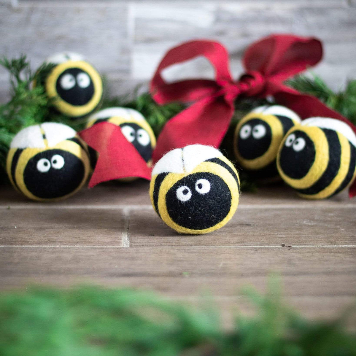 Plush bee dryer balls, yellow-and-black striped round plush with smiling faces