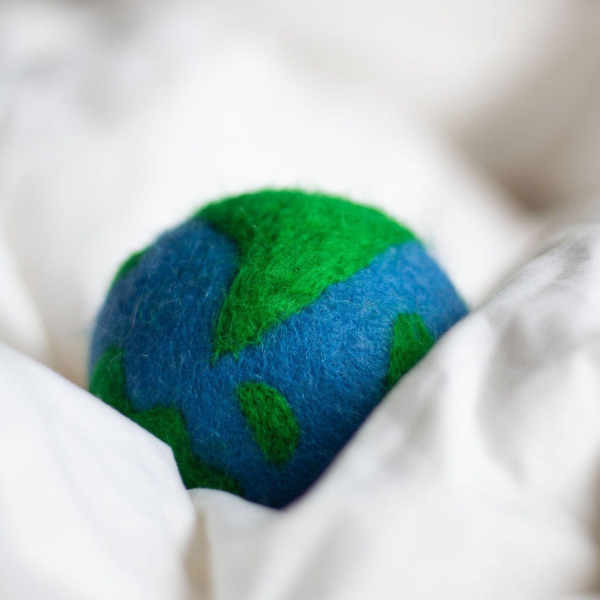 Felt globe plush with blue base and green planet land pattern