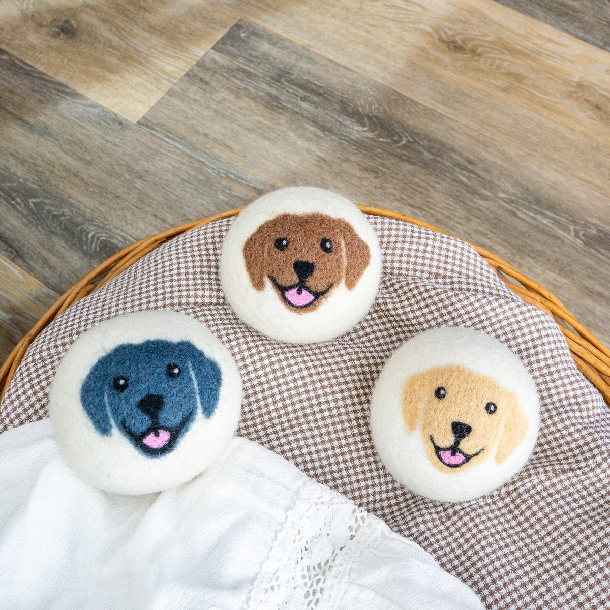Felt dog-face buttons in a wicker basket with gingham and white cloth lining.
