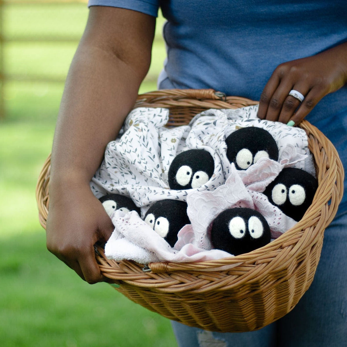 Laundry scent balls in a wicker basket: black plush faces and a few pale pieces