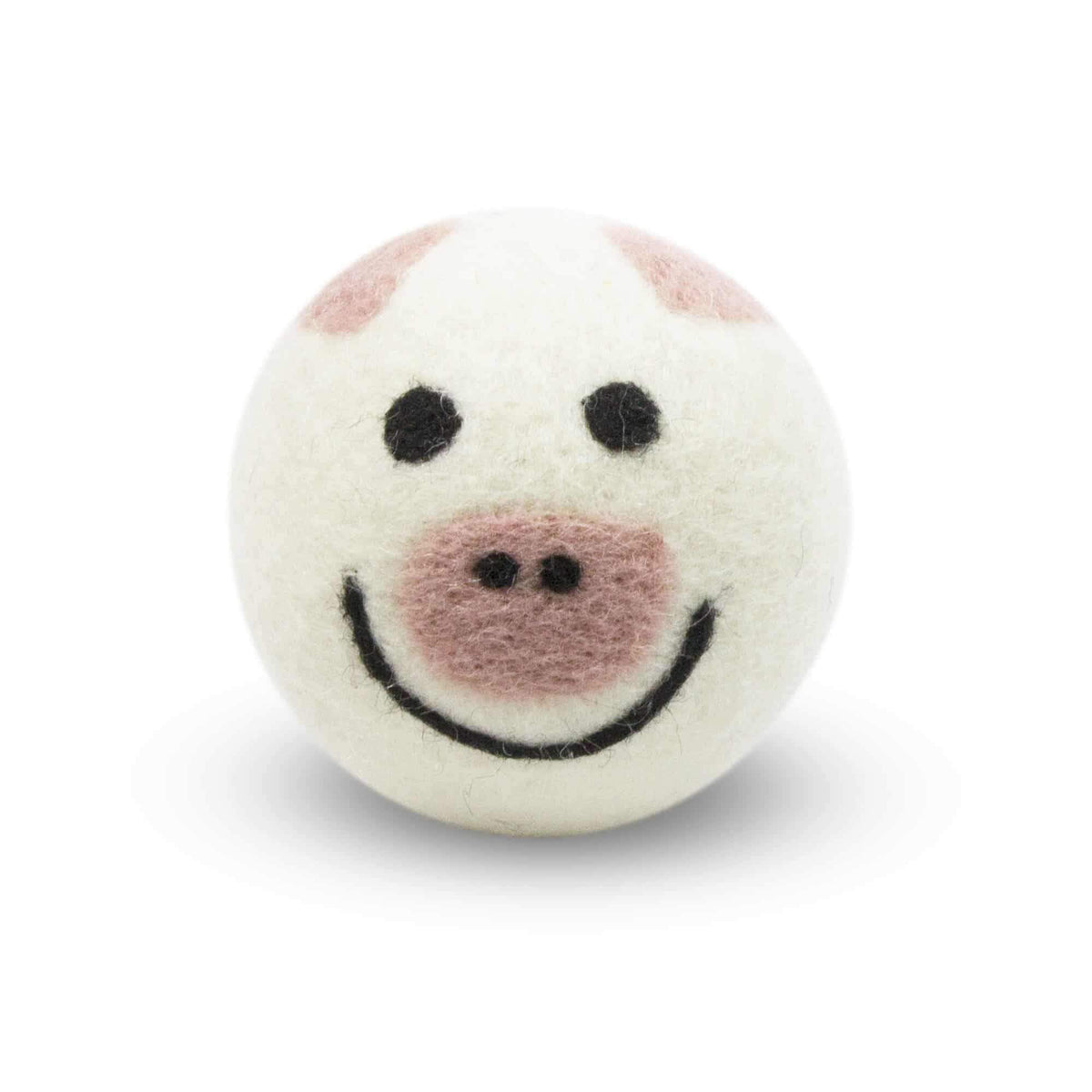 White felt pig-shaped dryer ball with black eyes and curved smile