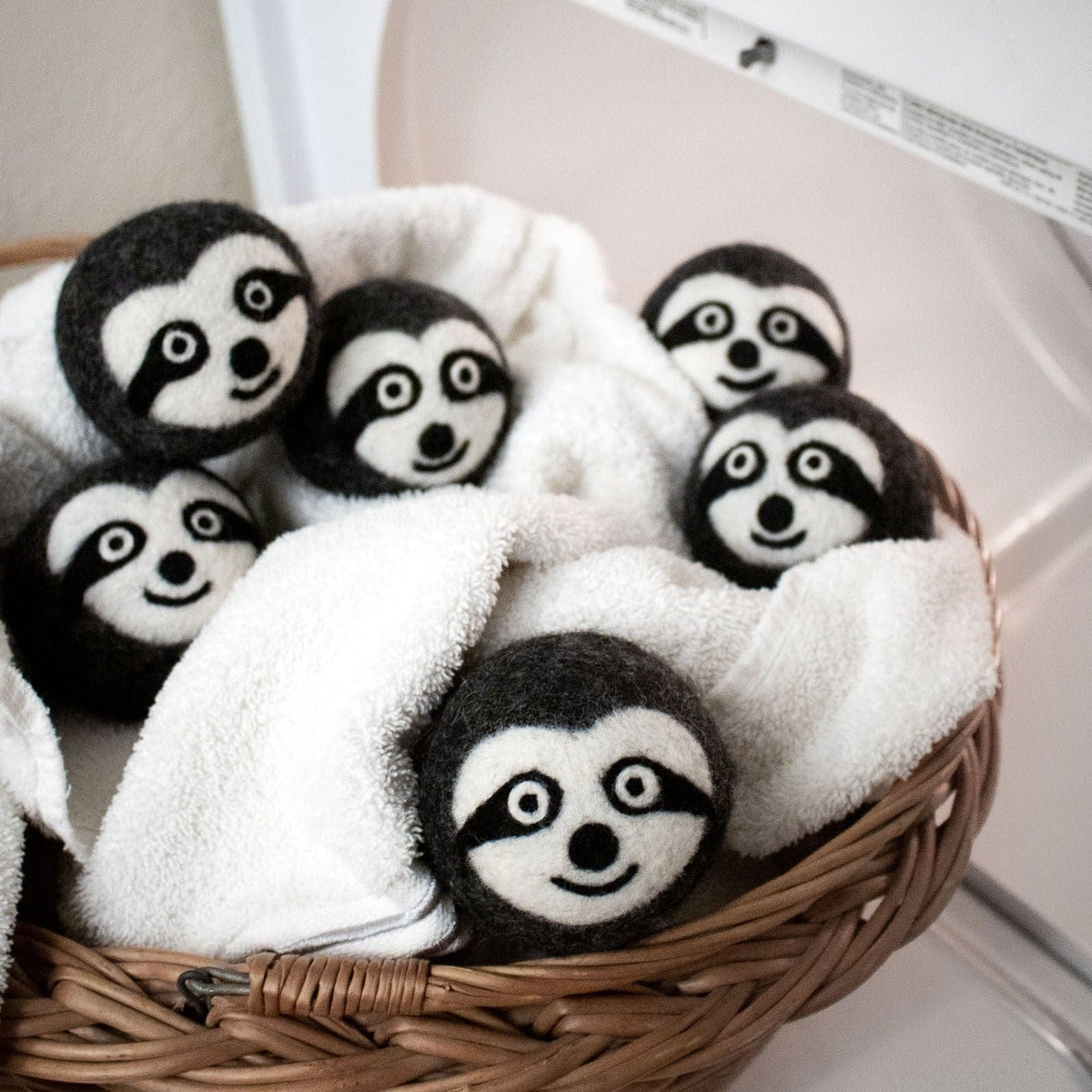 Felt sloth plush trio in wicker basket, with one centered in front