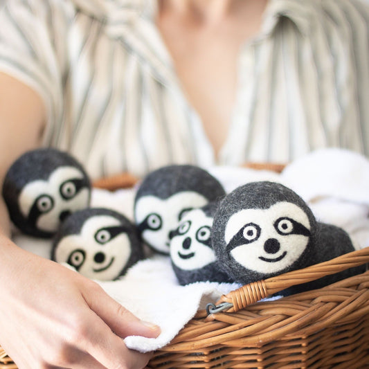 Felt sloth plush trio in a wicker basket with soft white backing