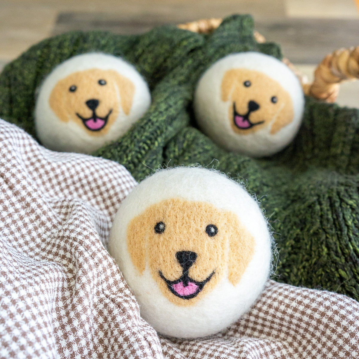 Two plush dog face patches on textured green knit fabric