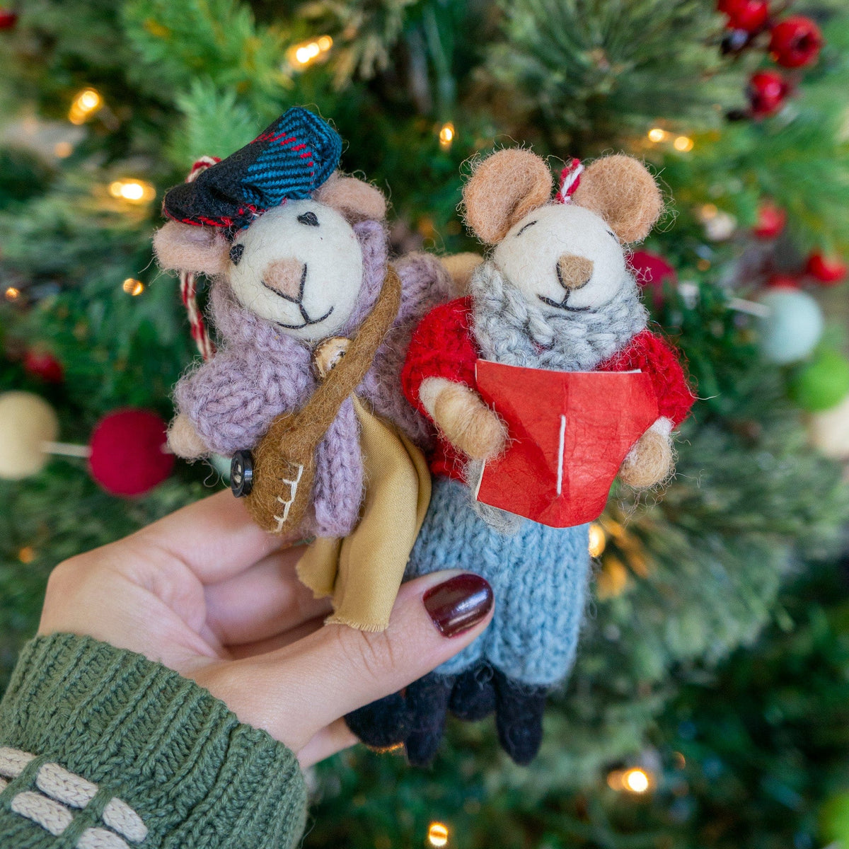Boho felt mouse ornaments held in hand on Christmas tree, guitar and red gift details
