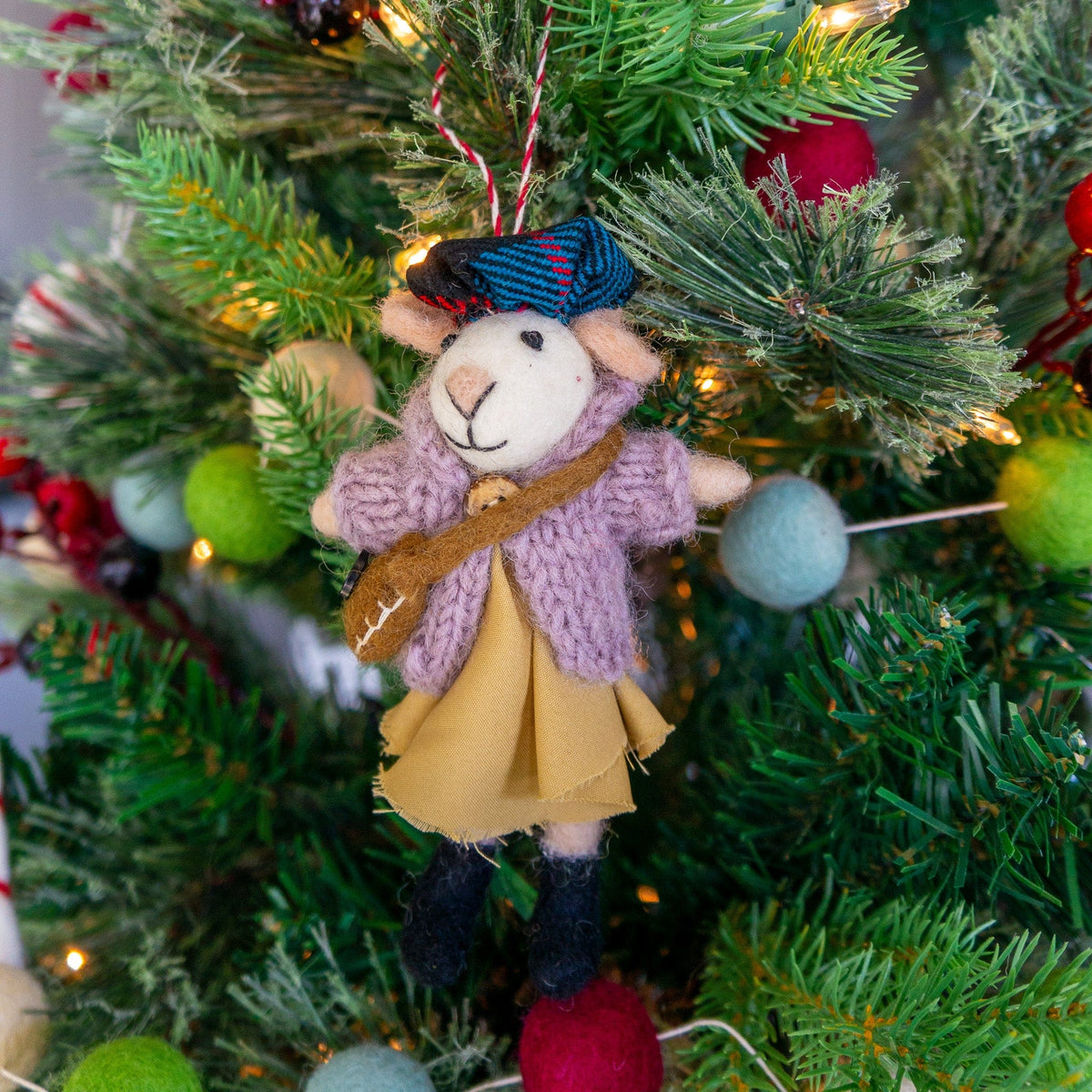Boho felt mouse eco ornament with guitar and yellow skirt, hanging on evergreen branches