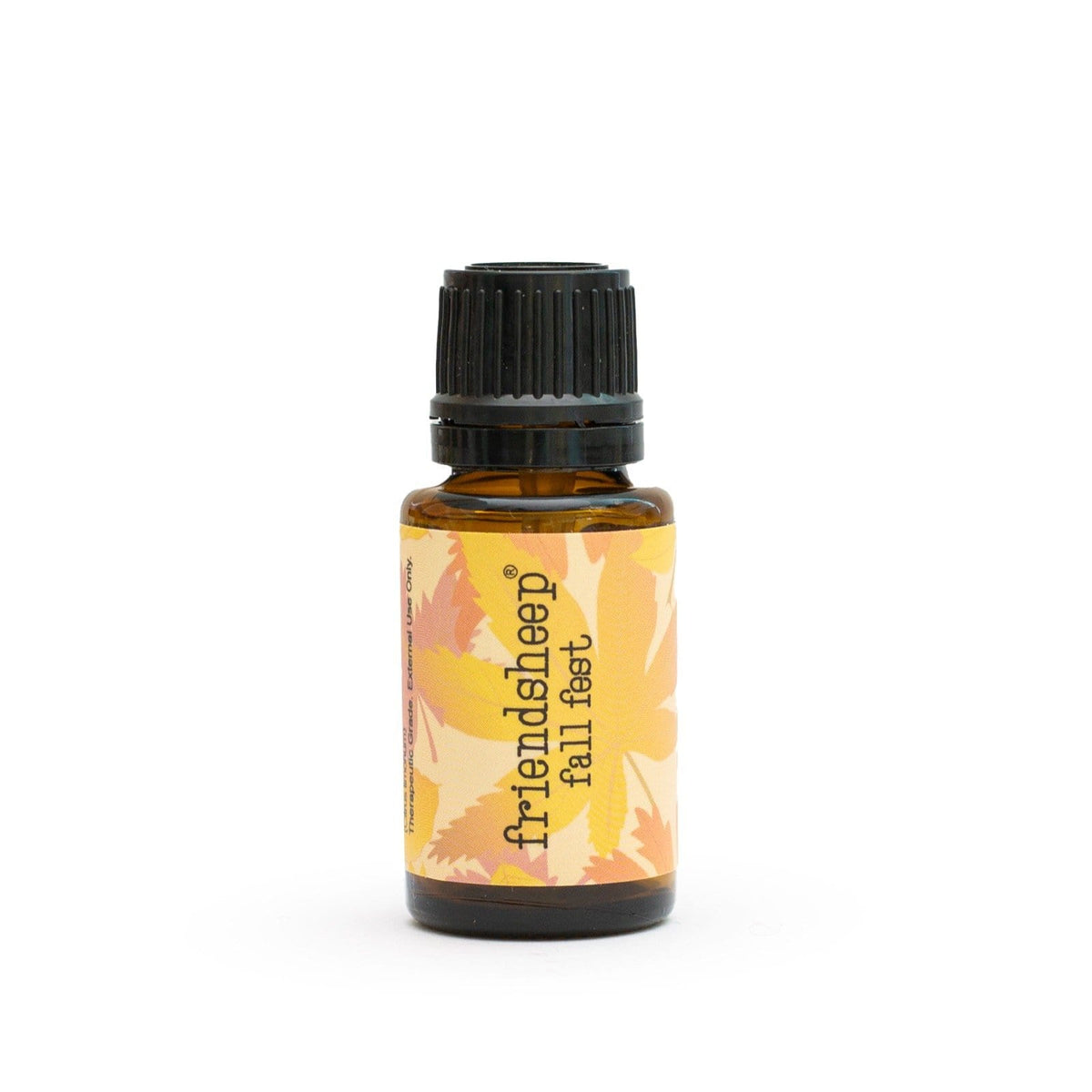 Glass essential oil bottle with black ribbed cap and fall leaf label