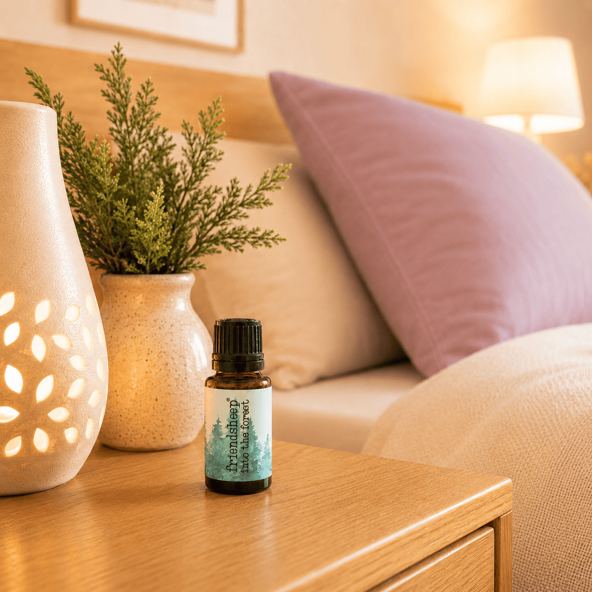 Amber essential oil blend bottle on wooden table with black ribbed cap and teal label