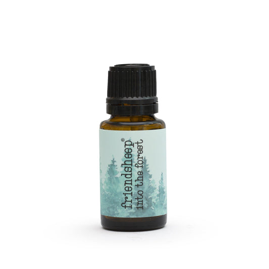 Amber essential oil blend bottle with black ribbed cap and teal forest label